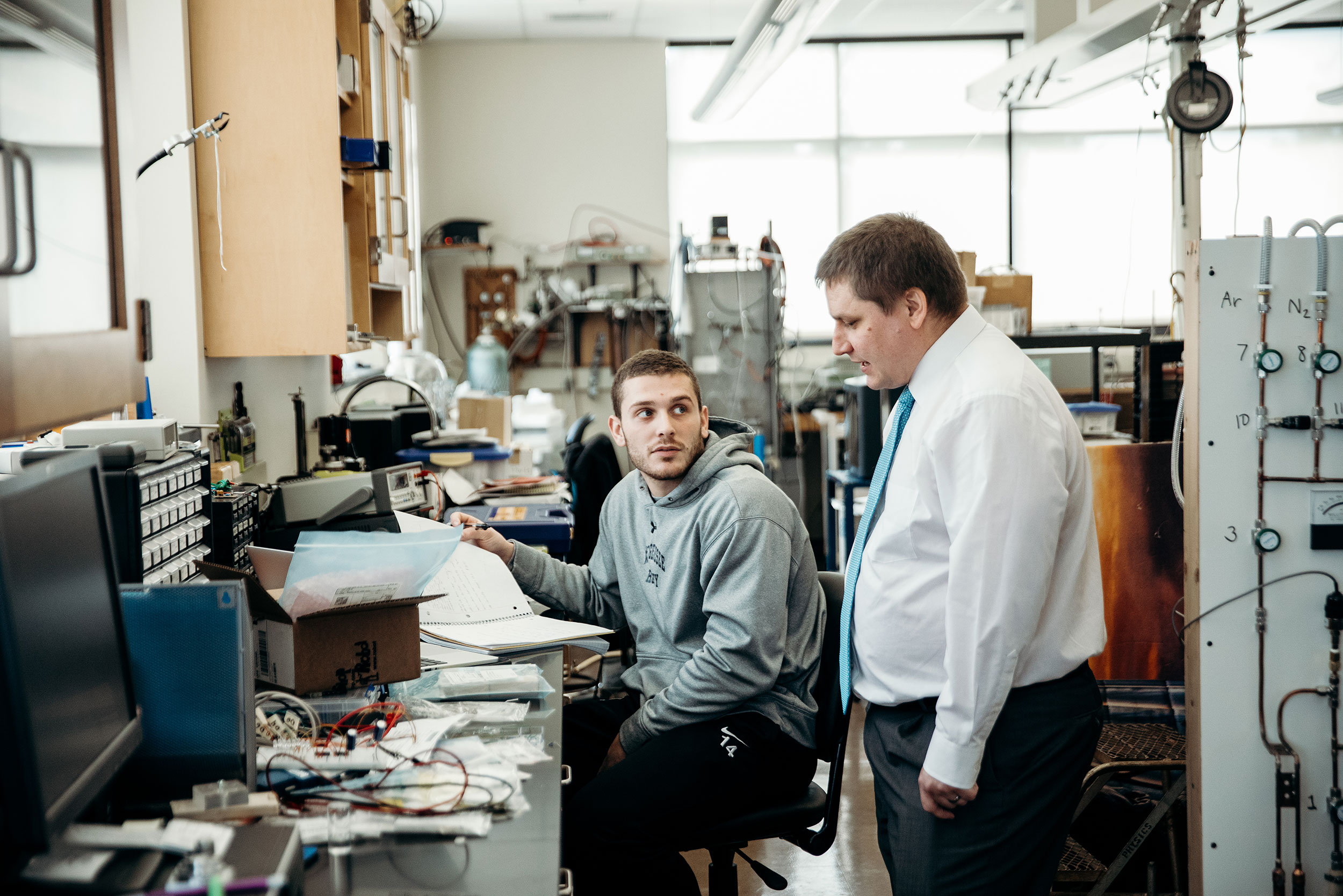 student with teacher in physics lab