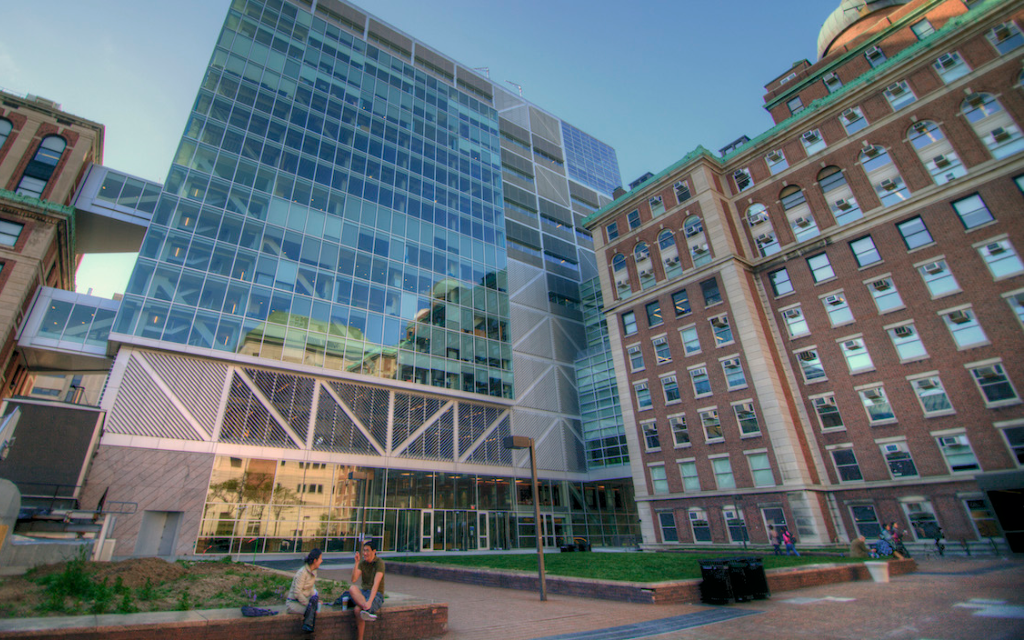 Artistic shot of a glass building attached to a brick building.